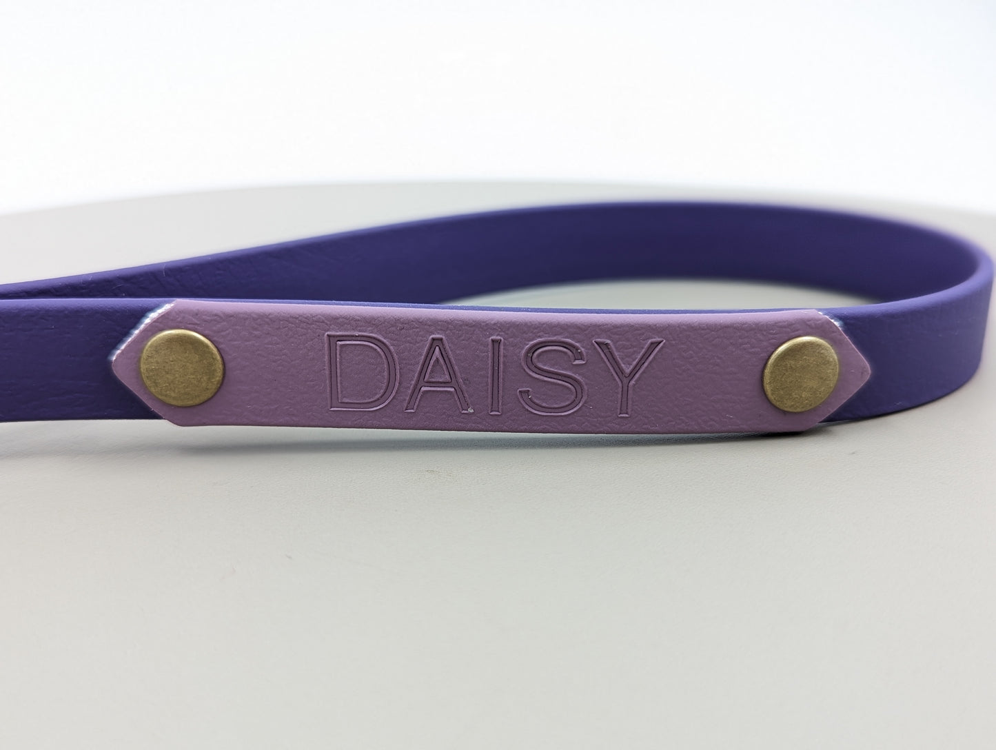 A heat stamped biothane personalized plate for dog collars and leads