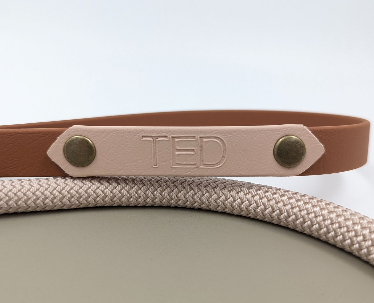 A heat stamped biothane personalized plate for dog collars and leads