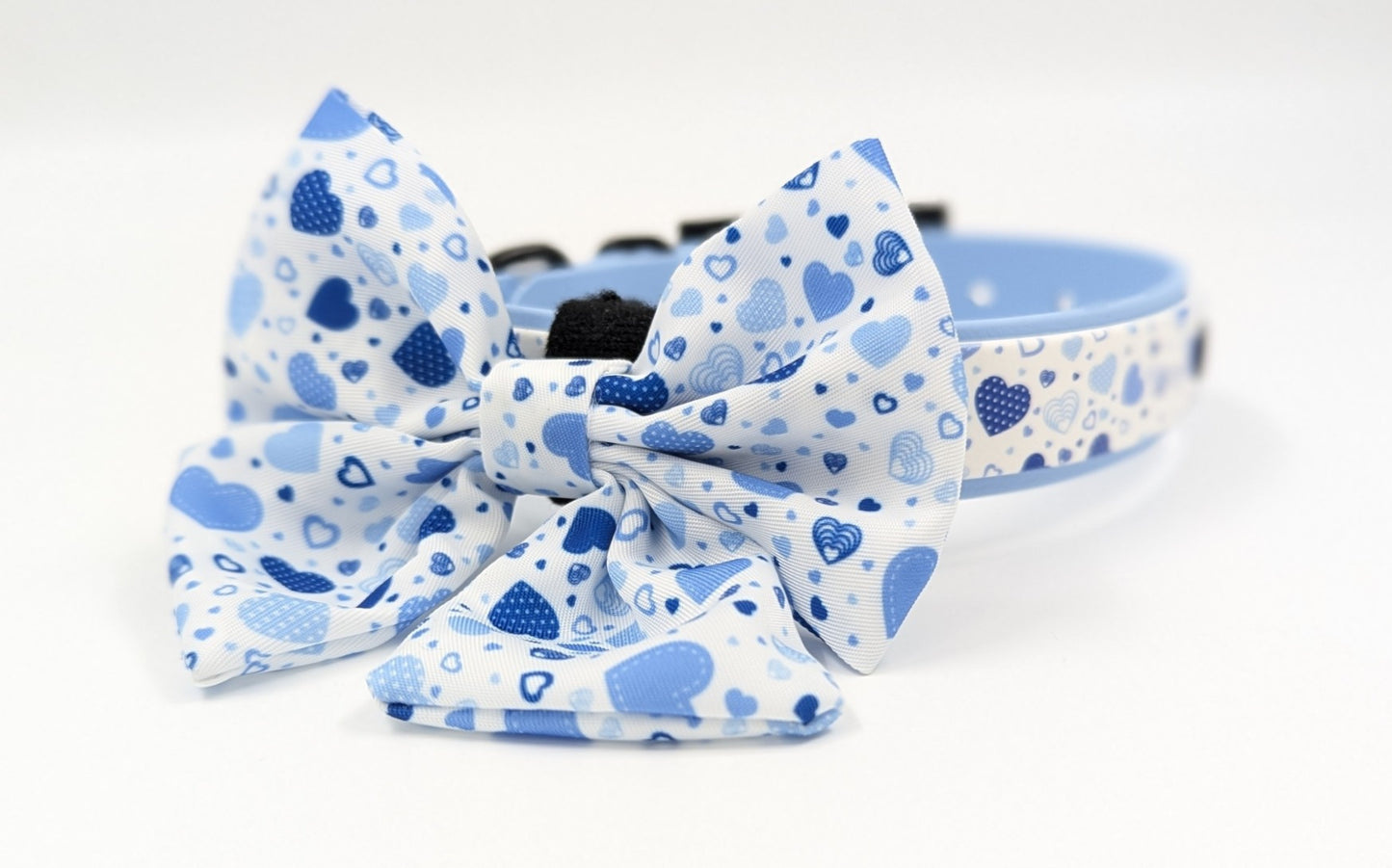 Handmade BioThane dog collar in blue with a layer of UV printed BioThane in cute blue hearts pattern Ireland worldwide with matching sailor bow