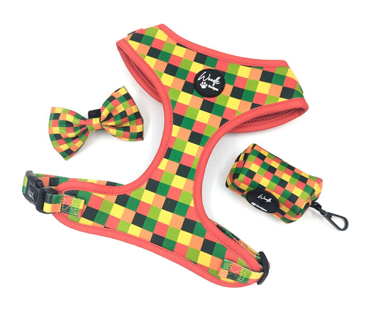 A dog harness set with a matching bow tie and small poo waste bag pouch, featuring a colorful checkered pattern in red, yellow, green, and black on a white background. Pixel Pawty. Ireland and worldwide. fast shipping. 