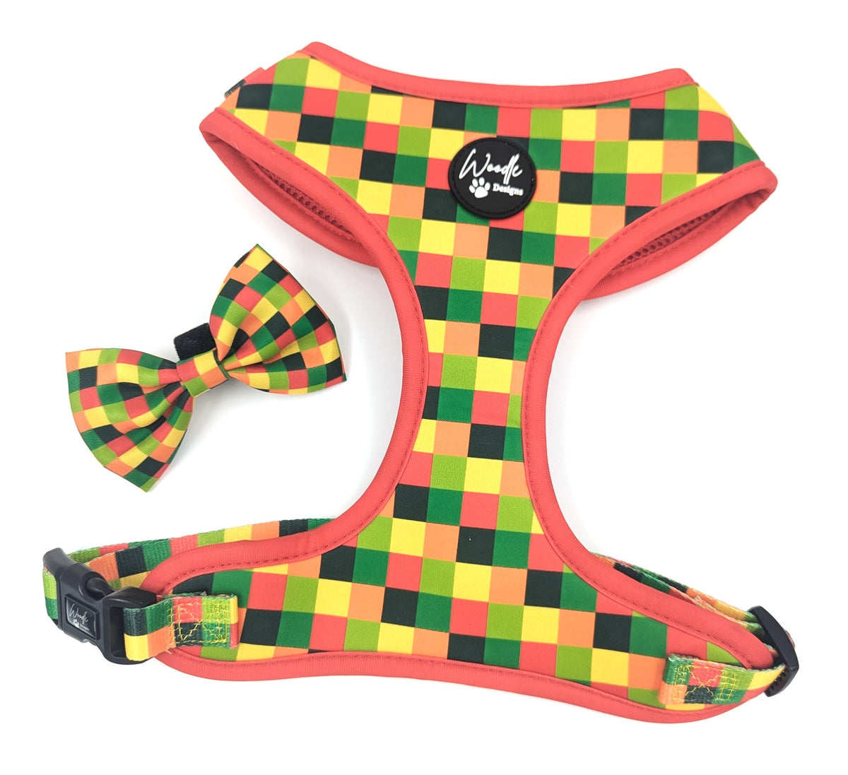 An adjustable cute dog harness and matching bow tie set in a red, yellow, green, and black checkerboard pattern, displayed on a clean white background. Ireland, UK and Worldwide. 
