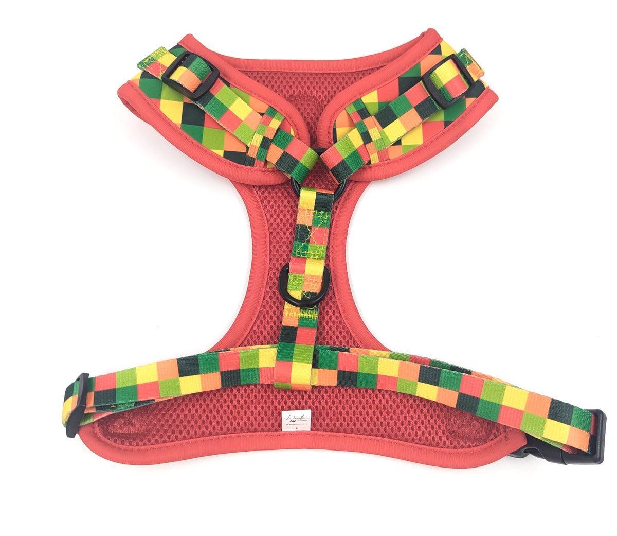 A red dog harness with a colorful checkered pattern strap in green, yellow, and red, shown against a plain white background. Ireland and worldwide.